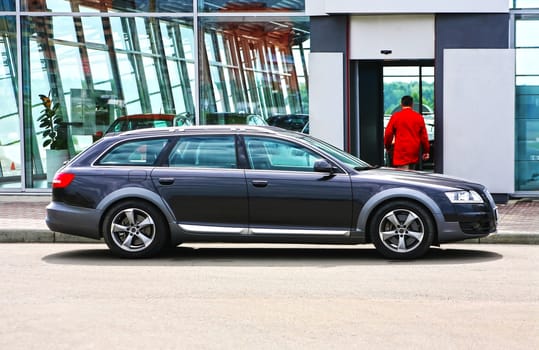 big prestigious grey car near motor show