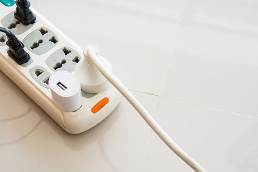 the beautiful 3d colorful plugs and one socket isolated on tile background