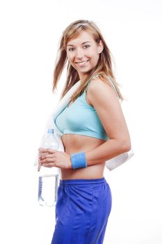 young woman in sports outfit holding a bottle of water smiling - islotad on white