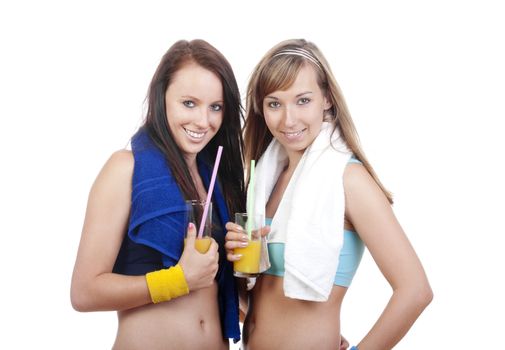 young women in sports outfit holding glasses with juice, smiling - isolated on white