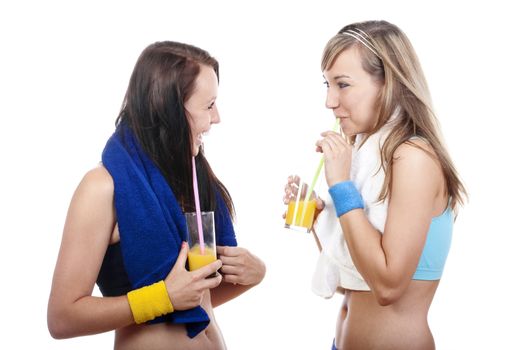 young woman in sports outfit drinking juice, talking - isolated on white