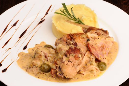 Stewed rabbit legs with potato puree and rosemary