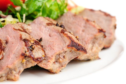 Macro closeup grill roasted veal meat with fresh vegetable salad