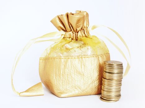 Golden money bag with a stack of golden Indian currency coins, isolated on white. Suitable for wealth building and money saving concepts
