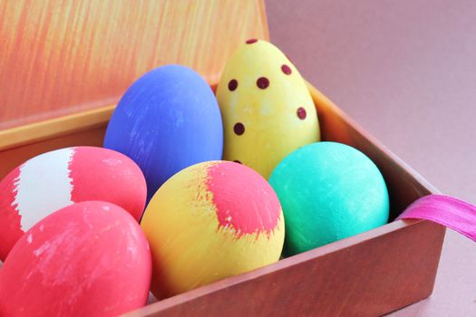 Colorful painted Easter eggs on a gift box.
