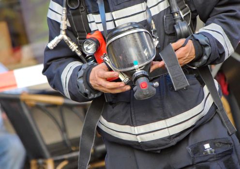 Close up on firefighter man holding oxygen or gas mask in his hands
