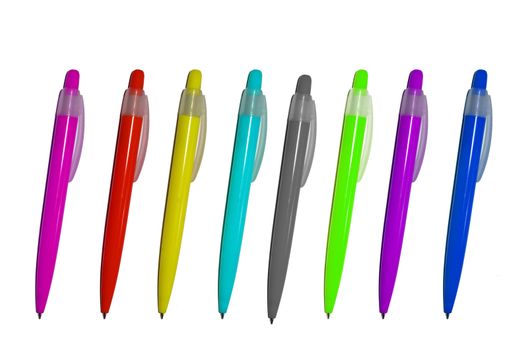 Colourful pens and pencils in a blue glass isolated on a white background