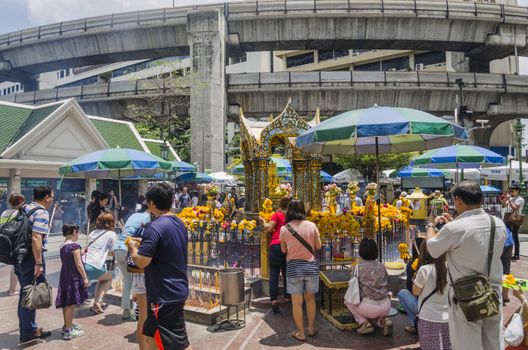 BANGKOK - 3 July 2014 : People pray respect the shrine of the four-faced Brahma statue at Ratchaprasong Junction on July 3, 2014 in Bangkok,Thailand.