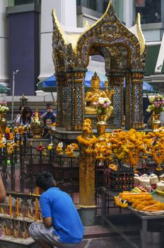 BANGKOK - 3 July 2014 : People pray respect the shrine of the four-faced Brahma statue at Ratchaprasong Junction on July 3, 2014 in Bangkok,Thailand.