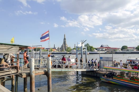 BANGKOK - JULY 3: Group of people aboarding to chao phraya ferry boat, Chao Phraya is a major river in Thailand, low alluvial plain forming the centre of the country. July 3, 2014 in Bangkok,Thailand