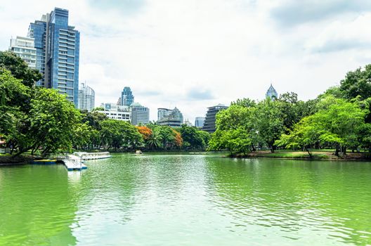 BANGKOK - july 3: Lake view of Lumpini Park in the Thai capital's city centre on july 3, 2014 in Bangkok, Thailand. Lumpini Park covers 142 acres with 2.5 km of pathways and a large boating lake.