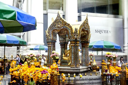 BANGKOK - 3 July 2014 : People pray respect the shrine of the four-faced Brahma statue at Ratchaprasong Junction on July 3, 2014 in Bangkok,Thailand.