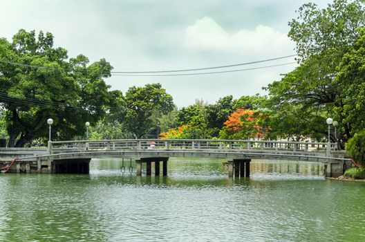 BANGKOK - july 3: Lake view of Lumpini Park in the Thai capital's city centre on july 3, 2014 in Bangkok, Thailand. Lumpini Park covers 142 acres with 2.5 km of pathways and a large boating lake.