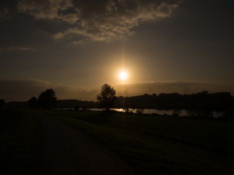 Silhouette sunset over river Ijssel in Holland