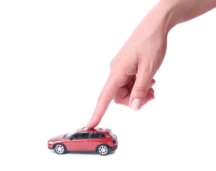 Female hand and the red toy car