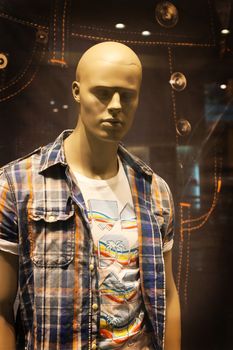 Dummy young man in shop show-window