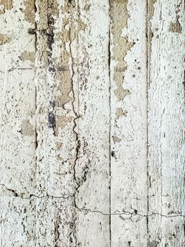 Old grungy concrete wall with peeling paint.