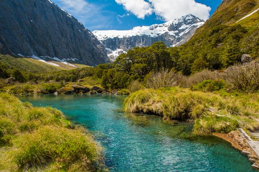 Gertrude Saddle with a snowy mountains and a turquoise lake, Fiordland national park, New Zealand South island