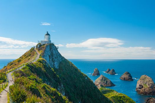 Lighthouse on Nugget Point. It is located in the Catlins area on the Southern Coast of New Zealand, Otago region. The Lighthouse is surrounded by small rock islands, nuggets