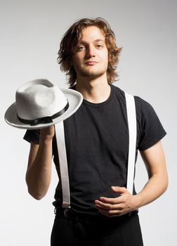 Portrait of a Young Man with Brown Hair Holding a White Hat