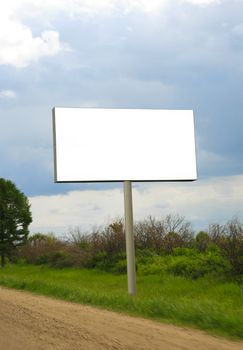 White rectangular billboard near road against the sky.