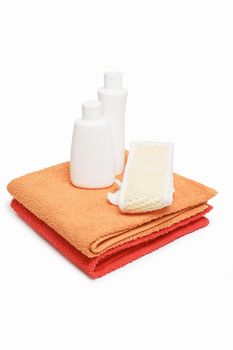Towels bast and shampoo on white background