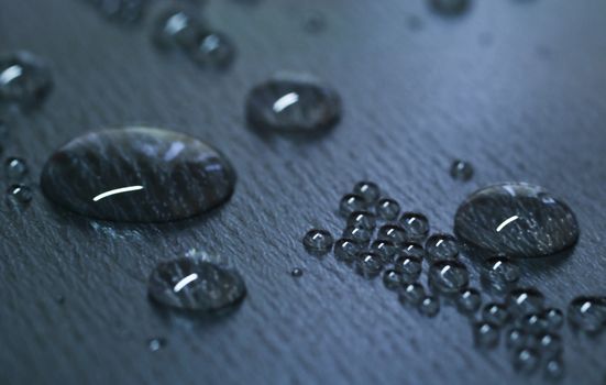 Water drops on dark teflon surface