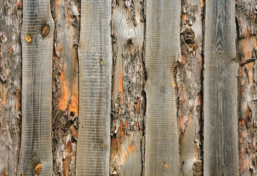 Wooden fence hammered together from rough pine boards