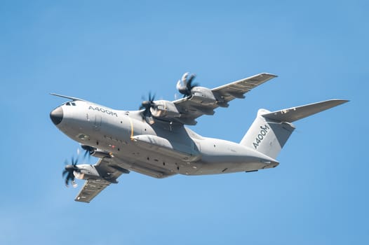 Farnborough, UK - July 18, 2014: Closeup of an Airbus A400M military and emergency aid transporter aircraft in low-level flight over Farnborough, Hampshire, UK