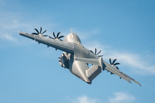Farnborough, UK - July 18, 2014: Closeup of an Airbus A400M military transporter aircraft in a steep climb after take-off from Farnborough, Hampshire, UK