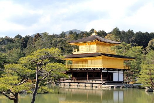 Photo shows old Japanese golden temple in the middle of the park.