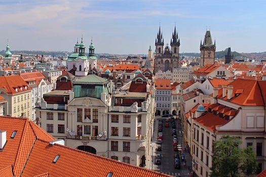 Photo shows details of Prague red roofs and old houses.