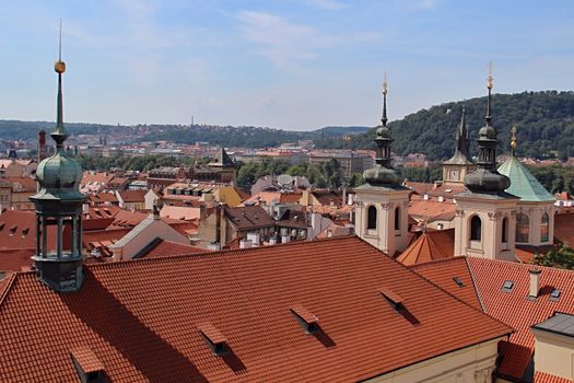 Photo shows details of Prague red roofs and old houses.