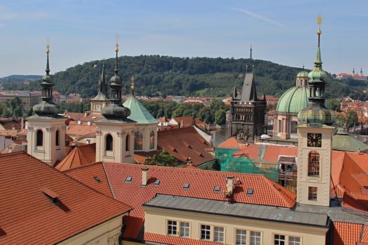 Photo shows details of Prague red roofs and old houses.