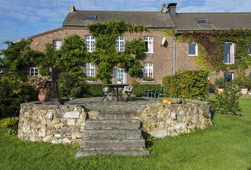 old farmers place with terrace from old rocks with chairs and tables