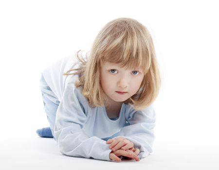 boy with long blond hair on the floor, looking at camera - isolated on white