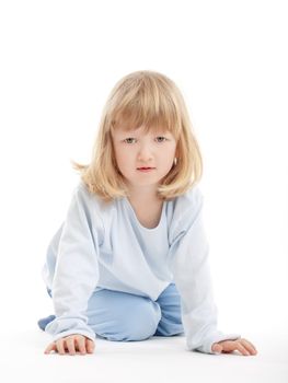 boy with long blond hair on the floor, looking at camera - isolated on white