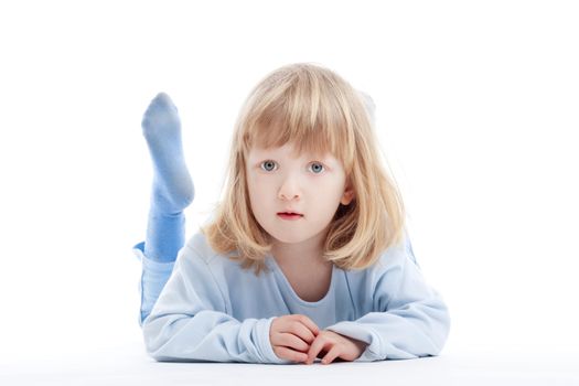 boy with long blond hair on the floor, looking at camera - isolated on white