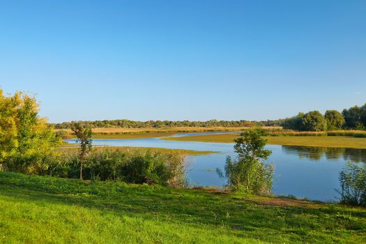 Lakeside landscape in autumn sunny weather