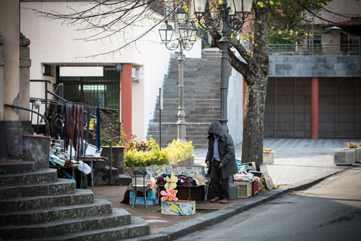 Peddler selling various object in a public place