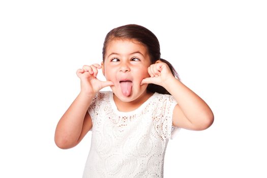 Cute girl making funny face sticking tongue out and crossed eyes, isolated.