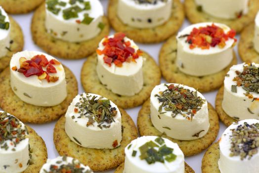 Close-up of cheese appetizers decorated with spices and vegetable