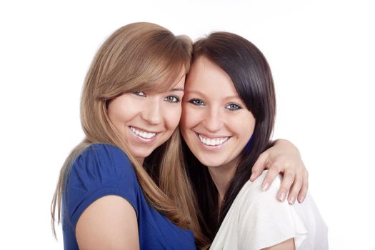 two happy young women standing, smiling - isolated on white