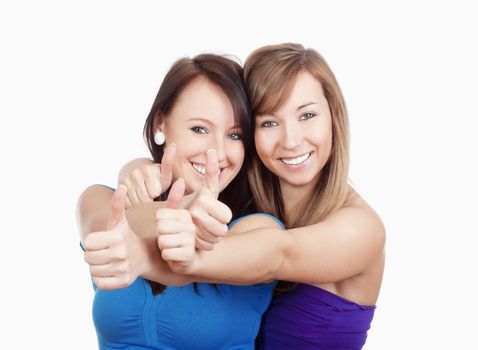 two young women showing thumbs up, smiling - isolated on white