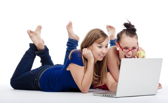 two young female friends having fun with laptop computer