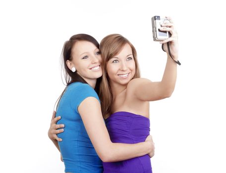 two young women taking pictures with digital camera - isolated on white