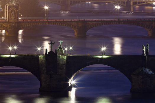 prague - bridges over vltava river at dusk - charles bridge in focus