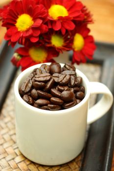 Coffee bean in cup on Bamboo tray.