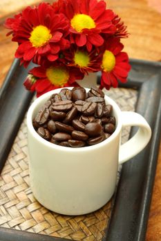 Coffee bean in cup on Bamboo tray.