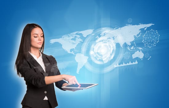 Beautiful businesswomen in suit using digital tablet. World map with glow circles, graphs and network